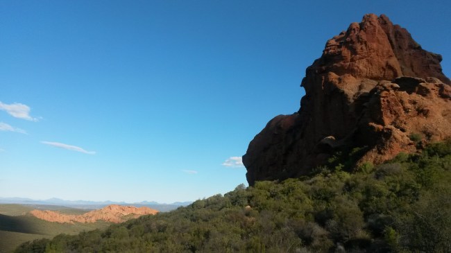 Red conglomerate hills in the foreground and distance. 