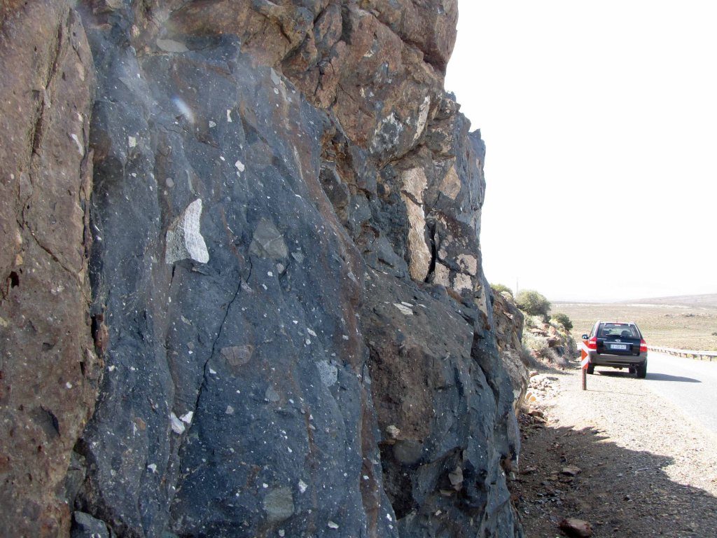 Dwyka diamictite roadcut, with car for scale. 