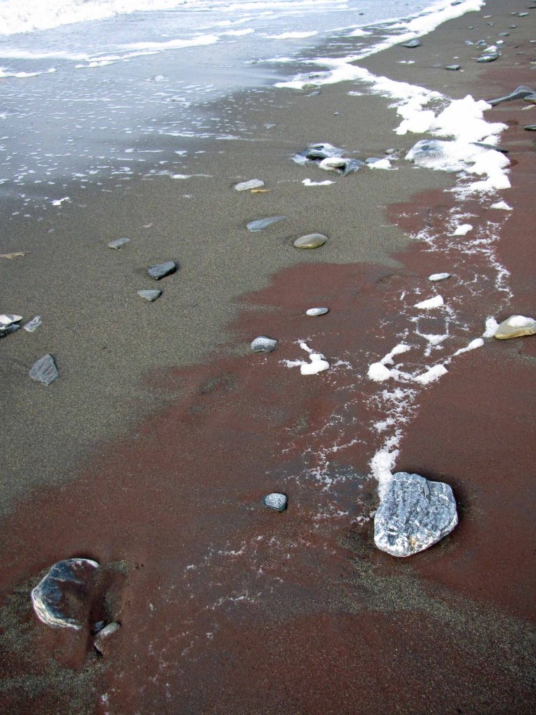 Gold-bearing garnet sands on Western Beach in Nome, Alaska, Summer 2012.